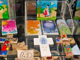 a glass display case filled with children ' s books and magnets