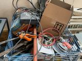 a cart full of assorted items and tools on the floor