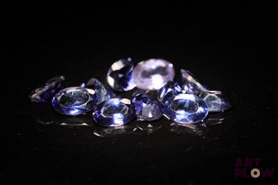 some very pretty blue and white diamonds on a black surface