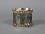 a close up of a silver plated ring on a table