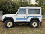 a picture of a white land rover parked in the grass