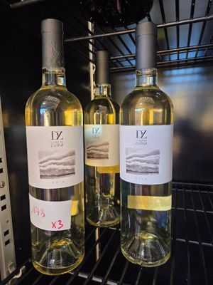 three bottles of wine sitting on a rack in the oven