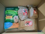 three bags of dog food in a cardboard box