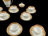 many cups and saucers sitting on a black table