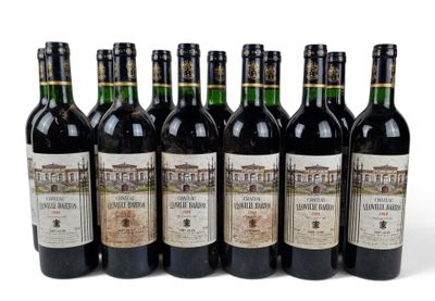 six bottles of wine are lined up in a row on a white surface