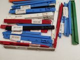 a lot of different colored clothes pegs on a table