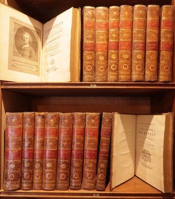 many old books on a wooden shelf in a room