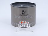 a silver crystal ring sitting on top of a silver container