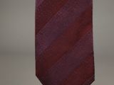 a close up of a red tie hanging on a wall