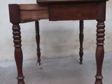 a small wooden table with a drawer on top of it