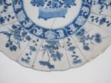 a blue and white plate with a picture of flowers on it