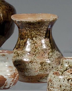 trois vases posés l'un à côté de l'autre sur une table