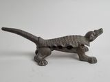an old bronze figurine of a dog with a collar and tail
