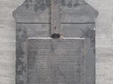 a wooden plaque on the wall with a cross on it