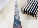 a spoon and a fork on a table with silverware