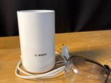 a table with a cup and a pair of glasses on it