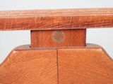a close up of a wooden chair with a wooden seat