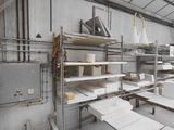a room that has many shelves and tables in it