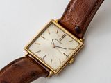 a close up of a watch on a white surface