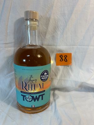 a bottle of liquor sitting on a white sheet