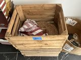 a wooden crate with a cat in it on the floor
