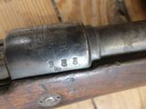 a close up of a gun that is on a wooden table