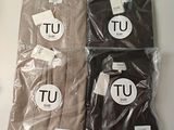 two brown t - shirts sitting on top of a table next to each other