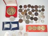 an assortment of silver and bronze coins including a clock and a red box