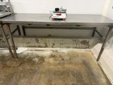 a metal table with a scale on it in a room