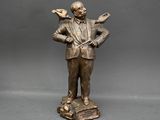 bronze statue of a man with a bird on his shoulder