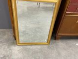 an image of a mirror sitting on top of a dresser next to a chest of drawers