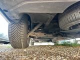 a close up of a car that is parked on the side of the road
