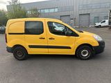the yellow van is parked in the parking lot outside of the building