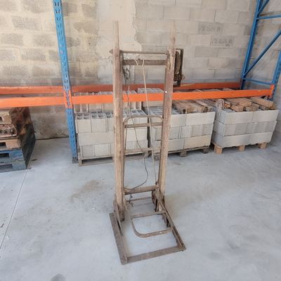 a small hand truck that is sitting in a warehouse