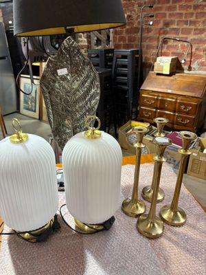 two lamps sitting on a table with a lamp on top of it