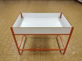 a white tray on a stand on a carpeted floor