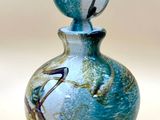 a glass bottle with a blue and white design on it