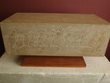 a stone box with carvings on it sitting on a table