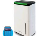 an image of a white air purifier sitting next to a cell phone