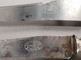 two knives that are sitting next to each other