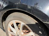 a close up of a black car with a flat tire