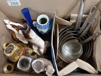 a cardboard box filled with assorted kitchenware and utensils