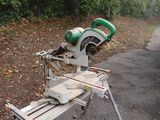 a saw that is sitting on the ground next to the road