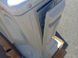 a white refrigerator sitting on top of a cardboard box