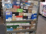 a metal cart with many boxes on it in a warehouse