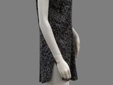 a mannequin wearing a black dress on a gray background
