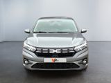 the front view of a silver car in a white room