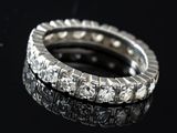 a close up of a diamond ring on a black surface