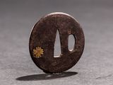 a small coin with a flower on it sitting on a table