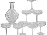 a lot of wine glasses and a decanter on the table